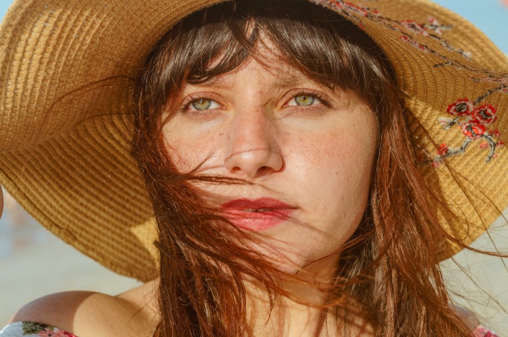 woman wearing brown sun hat