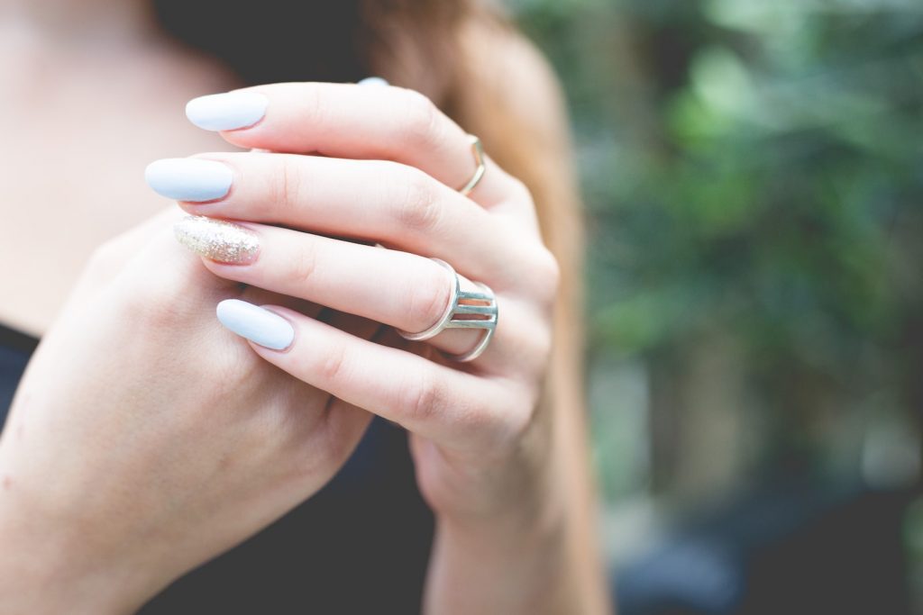 selective focus photography of woman wearing gold-colored ring